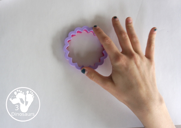 Flower Stamp Painting With Cookie Cutters - cookie cutter in the paint on the paper plate 3Dinosaurs.com