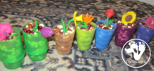Flowers And Bean Sensory Bin - a simple sensory bin with mixed beans and flowers in the beans with some cups - 3Dinosaurs.com