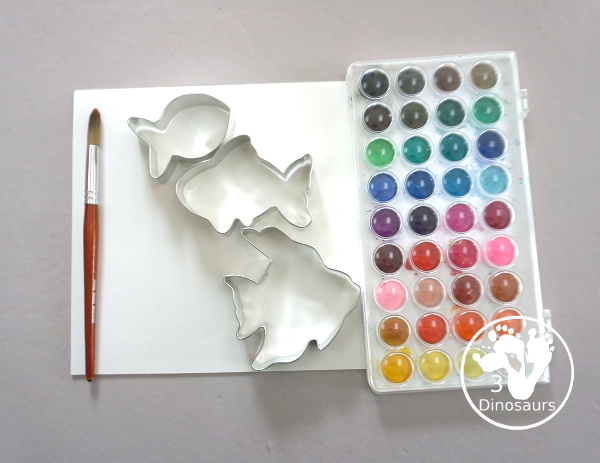 Fish Watercolor Painting with Cookie Cutters is an easy ocean fish painting you can do with kids. You can use one cookie cutter or several fish cookie cutters to make  the painting  - 3Dinosaurs.com