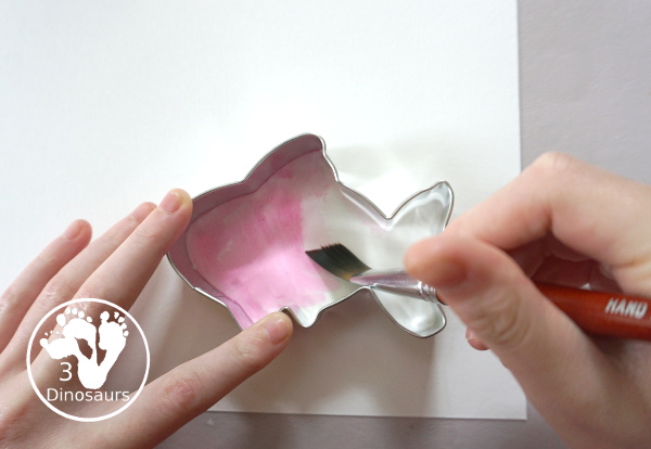 Fish Watercolor Painting with Cookie Cutters is an easy ocean fish painting you can do with kids. You can use one cookie cutter or several fish cookie cutters to make  the painting  - 3Dinosaurs.com
