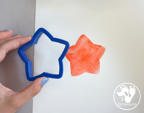 Stars & Flag Watercolor Painting with Cookie Cutters - a simple painting activity that you can do with kids with red and blue colors painting inside stars and flags.- 3Dinosaurs.com