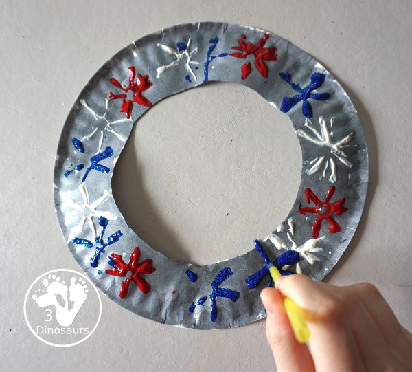 Red, White & Blue Straw Painted Fireworks Wreath - a fun firework themed wreath for the Fourth of July with red, white, and blue colors. A simple painting craft you can do with kids. - 3Dinosaurs.com