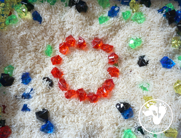 Olympic Flag Colors Sensory Bin - a simple sensory bin to explore the different colors that make the rings on the Olympic Flag - 3Dinosaurs.com