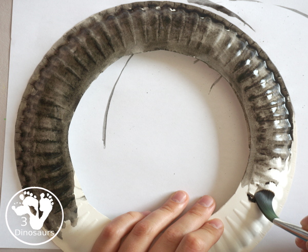 Scrapbook Paper Space Wreath Craft - a fun space craft for kids that is made with a paper plate, craft punches that are circles and stars with glitter paper and scrapbook paper. It makes a fun space craft. - 3Dinosaurs.com