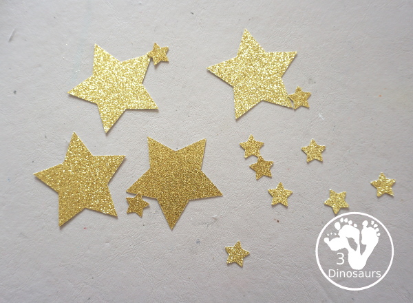 Scrapbook Paper Space Wreath Craft - a fun space craft for kids that is made with a paper plate, craft punches that are circles and stars with glitter paper and scrapbook paper. It makes a fun space craft. - 3Dinosaurs.com