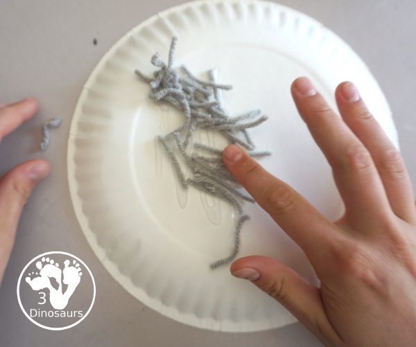 Yarn Moon Craft For Kids is simple to make with a paper plate, glue and yarn to make the moon. It is great for Moon Day or any moon theme you do with kids. - 3Dinosaurs.com