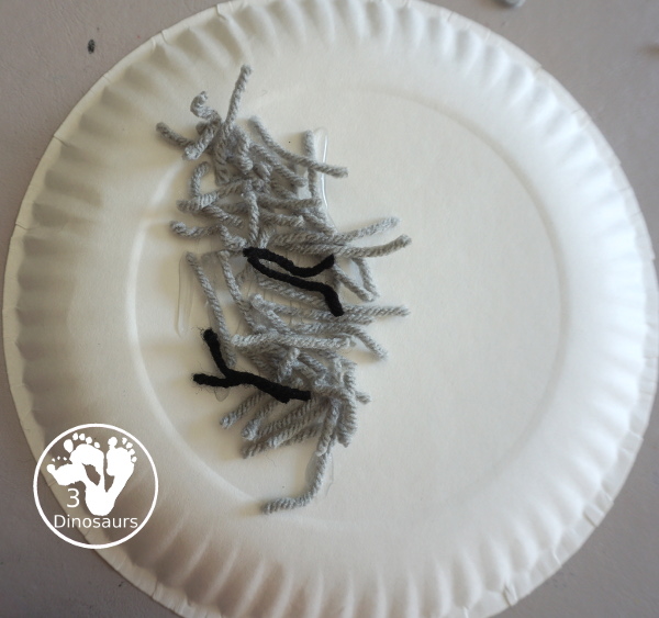 Yarn Moon Craft For Kids is simple to make with a paper plate, glue and yarn to make the moon. It is great for Moon Day or any moon theme you do with kids. - 3Dinosaurs.com