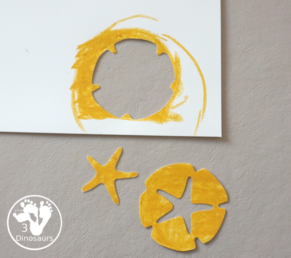 Beach Wreath Craft for Kids - a super easy to make beach craft with a wreath and shells kids can color and punch out to make the beach wreath. - 3Dinosaurs.com