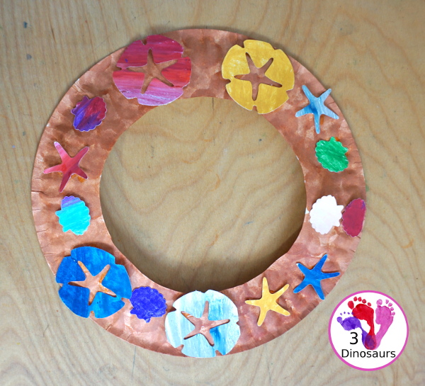 Beach Wreath Craft for Kids - a super easy to make beach craft with a wreath and shells kids can color and punch out to make the beach wreath. - 3Dinosaurs.com