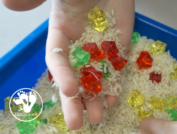 Red, Green and Yellow Sensory Bin - a simple rice and acrylic rock sensory bin with the colors of apples red, green and yellow. A simple time to setup and use. - 3Dinosaurs.com