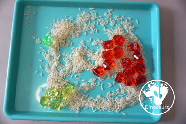 Red, Green and Yellow Sensory Bin - a simple rice and acrylic rock sensory bin with the colors of apples red, green and yellow. A simple time to setup and use. - 3Dinosaurs.com