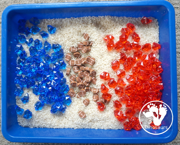 Football Sensory Bin - a simple football sensory bin for kids. You have a mix of green rocks, rice and footballs - 3Dinosaurs.com