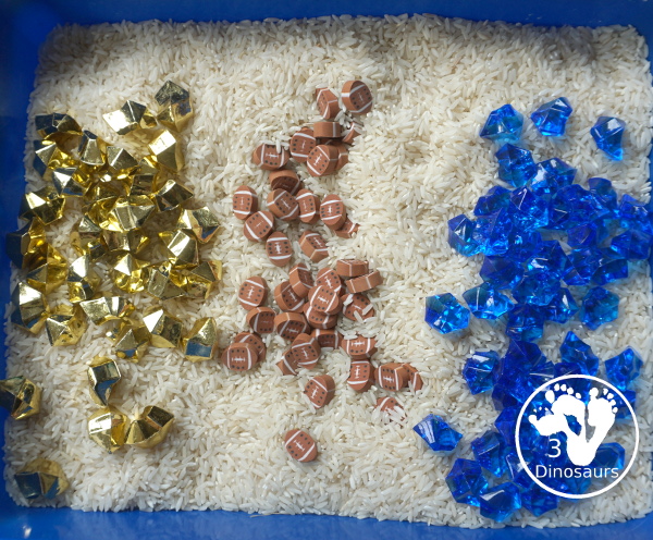 Football Sensory Bin - a simple football sensory bin for kids. You have a mix of green rocks, rice and footballs - 3Dinosaurs.com