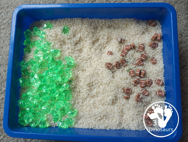 Football Sensory Bin - a simple football sensory bin for kids. You have a mix of green rocks, rice and footballs - 3Dinosaurs.com