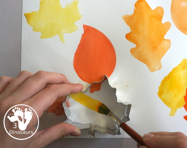 Leaves Cookie Cutter Painting - a fun fall painting wiht leaves. You can use a mix of red, yellow, orange and brown colors with this watercolor painting - 3Dinosaurs.com